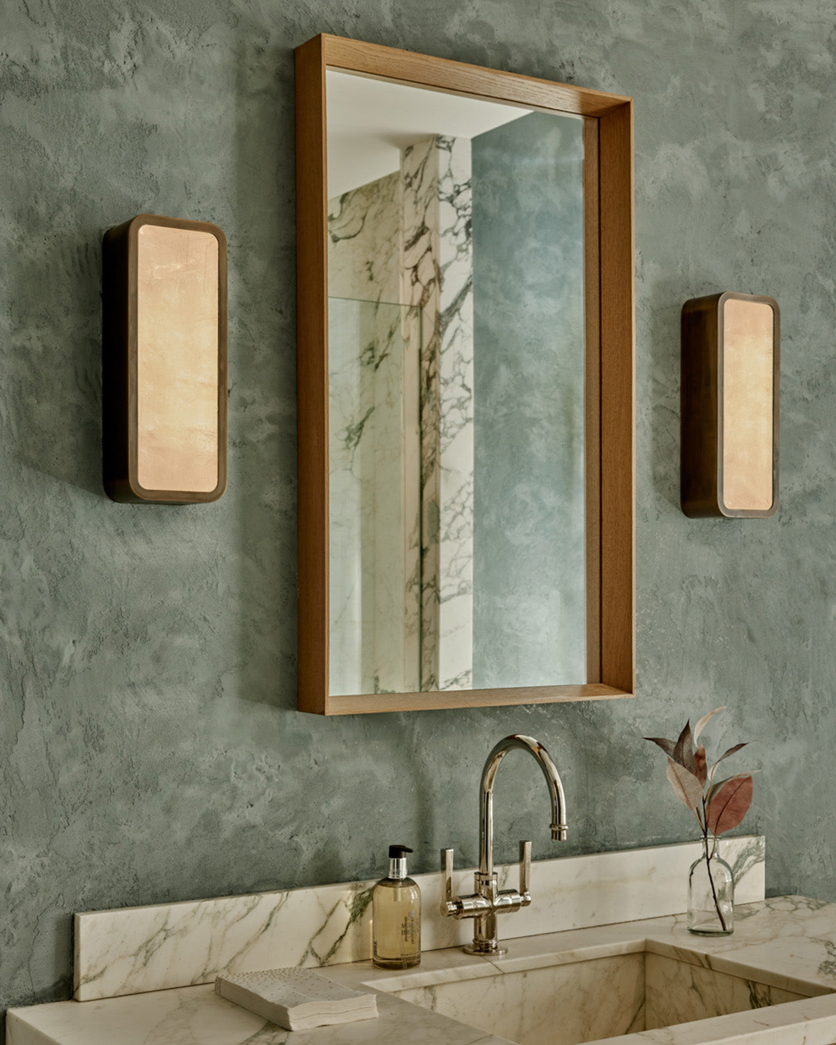 Robert True Ogden RTO Lighting - Two Tomer Sconce - Selenite Diffuser - Antique Brass Hung In Between a Mirror in a Bathroom